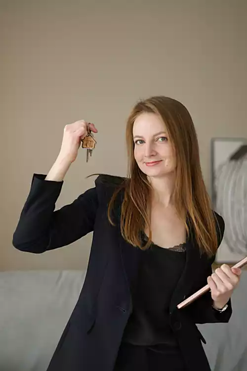 Real Estate Lead Nurturing - Female Agent Holding Keys