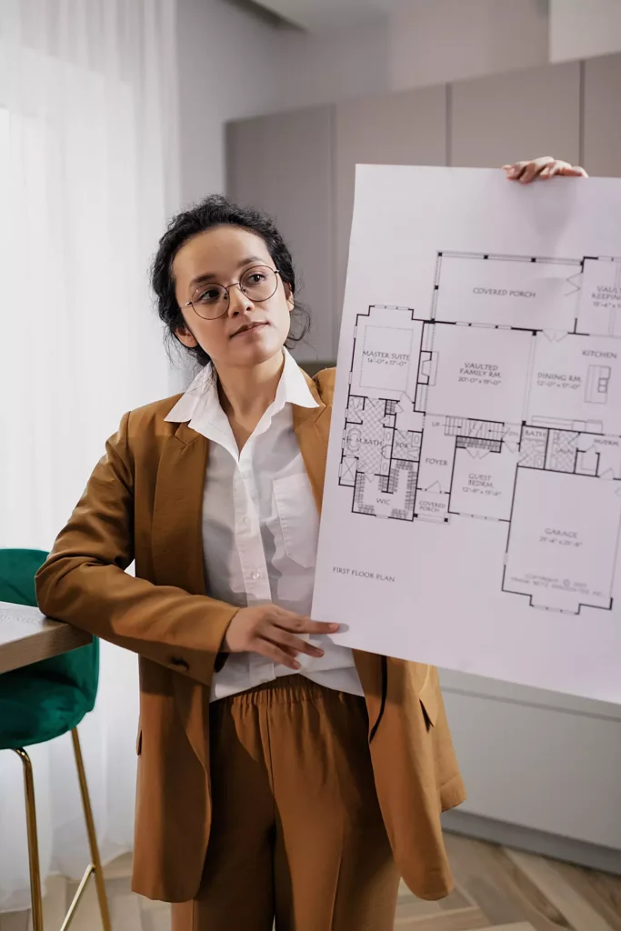 Real Estate Agent Holding floor plan sign